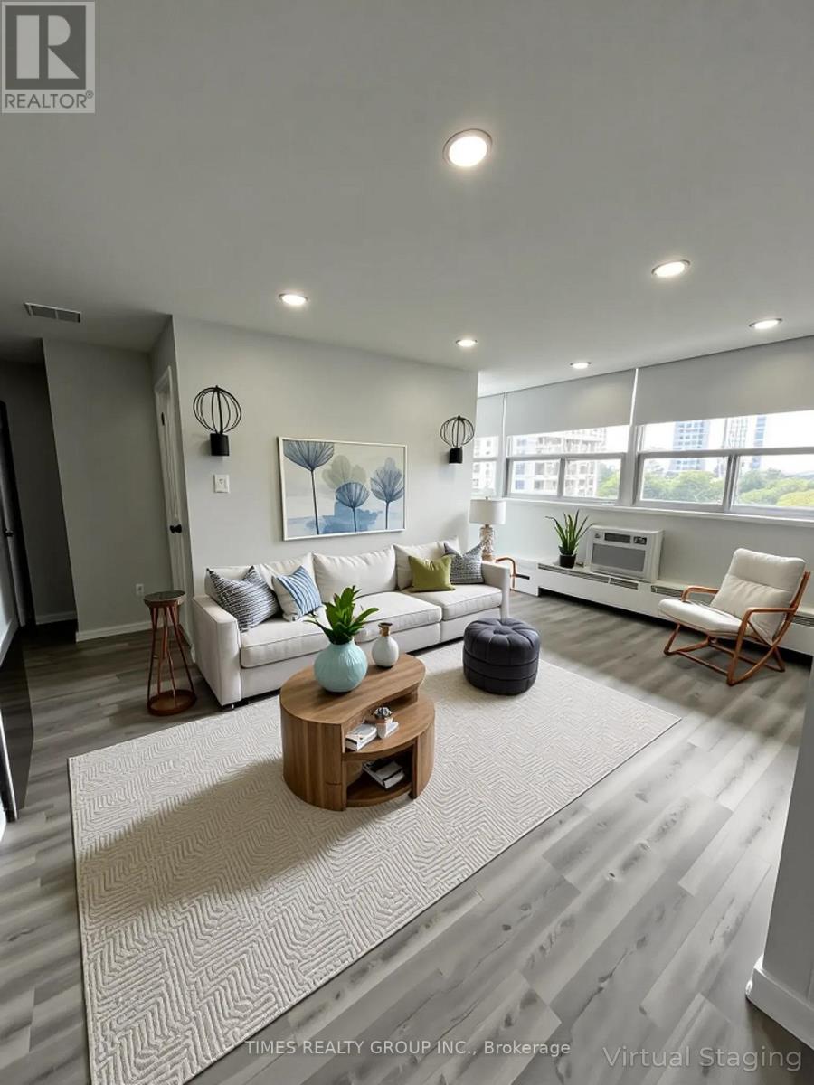A living room with a white couch, a wooden coffee table, and a rug.