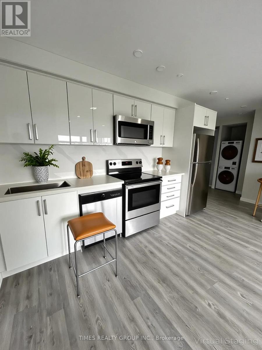 A modern kitchen with white cabinets and a wooden floor.