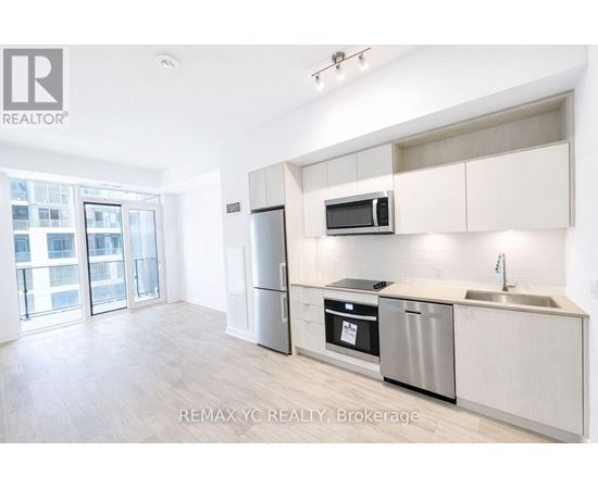 A kitchen with white cabinets and stainless steel appliances.
