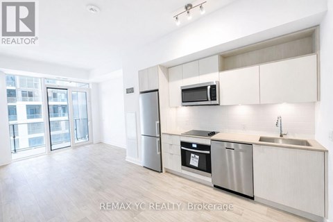 A kitchen with white cabinets and stainless steel appliances.
