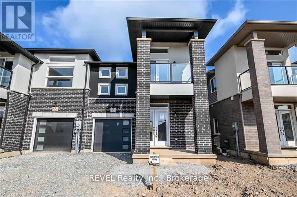 A modern house with a black and white facade is for sale.