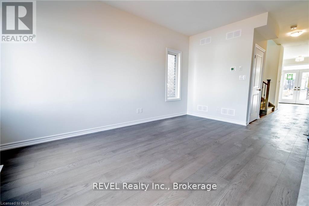 A room with a window and a door leading to another room.