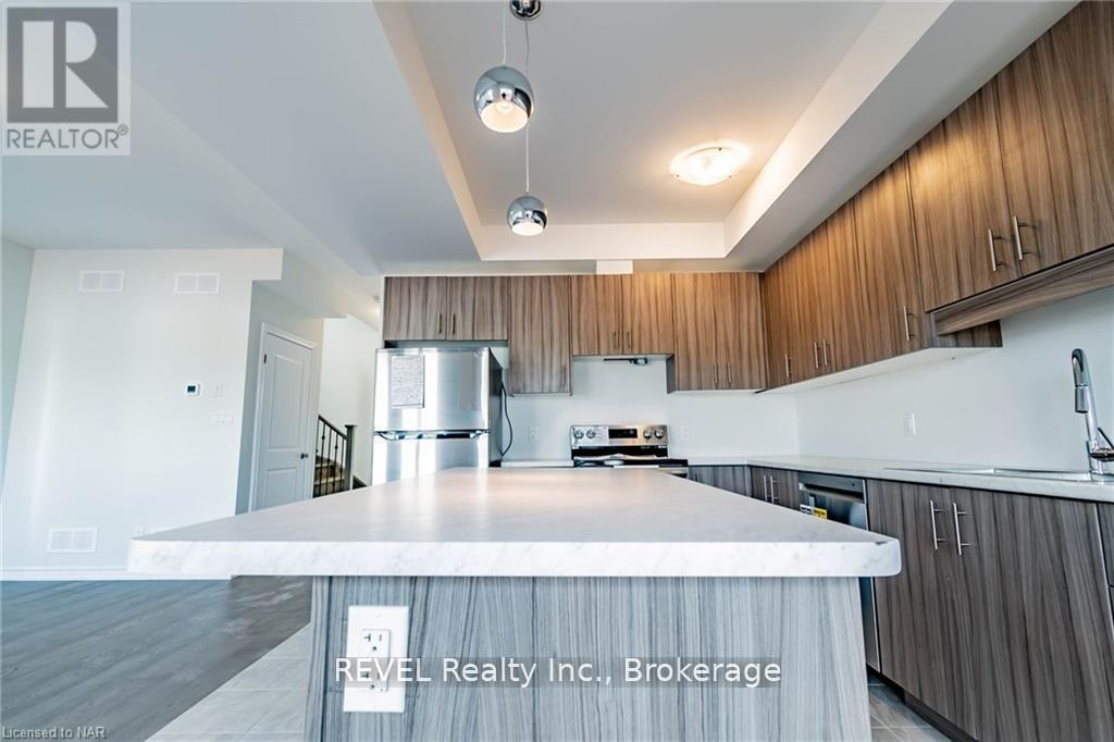 A modern kitchen with wooden cabinets and a central island.