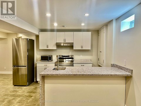 A kitchen with granite countertops and stainless steel appliances.
