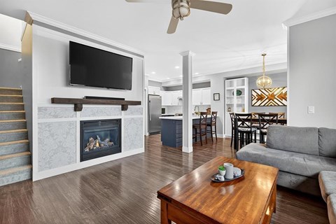 A modern living room with a fireplace and a television mounted above it.