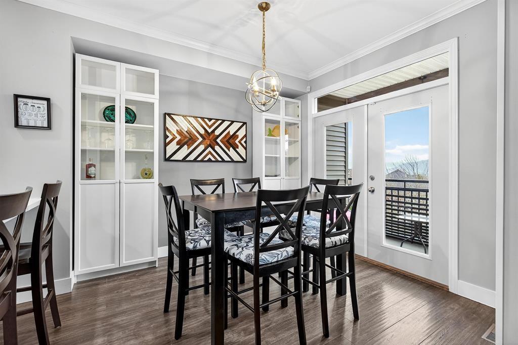 A dining room with a table set for six.