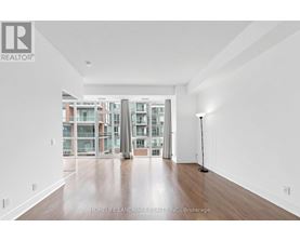 A spacious room with a view of a building outside the window.