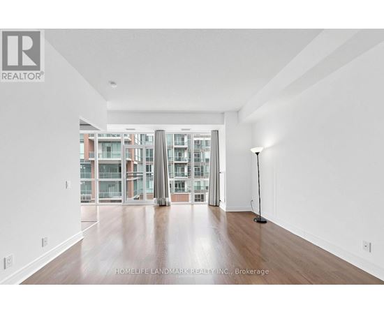 A spacious room with a view of a building outside the window.