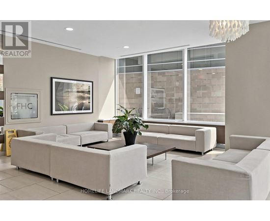 A well-lit living room with a large sofa and a coffee table.