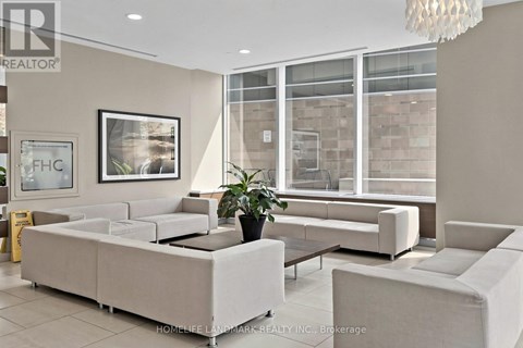 A well-lit living room with a large sofa and a coffee table.