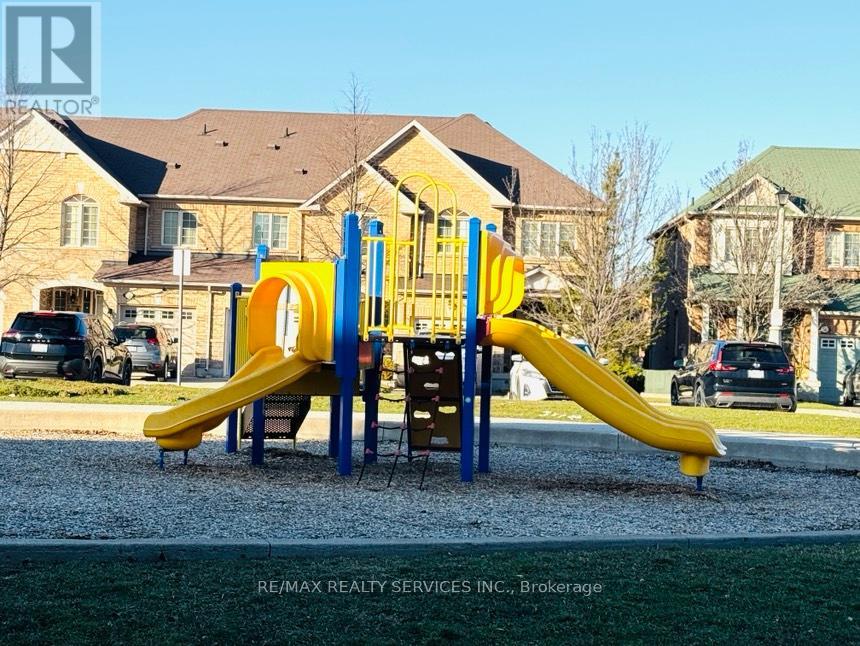 A playground with a yellow slide and a blue and yellow climbing frame.