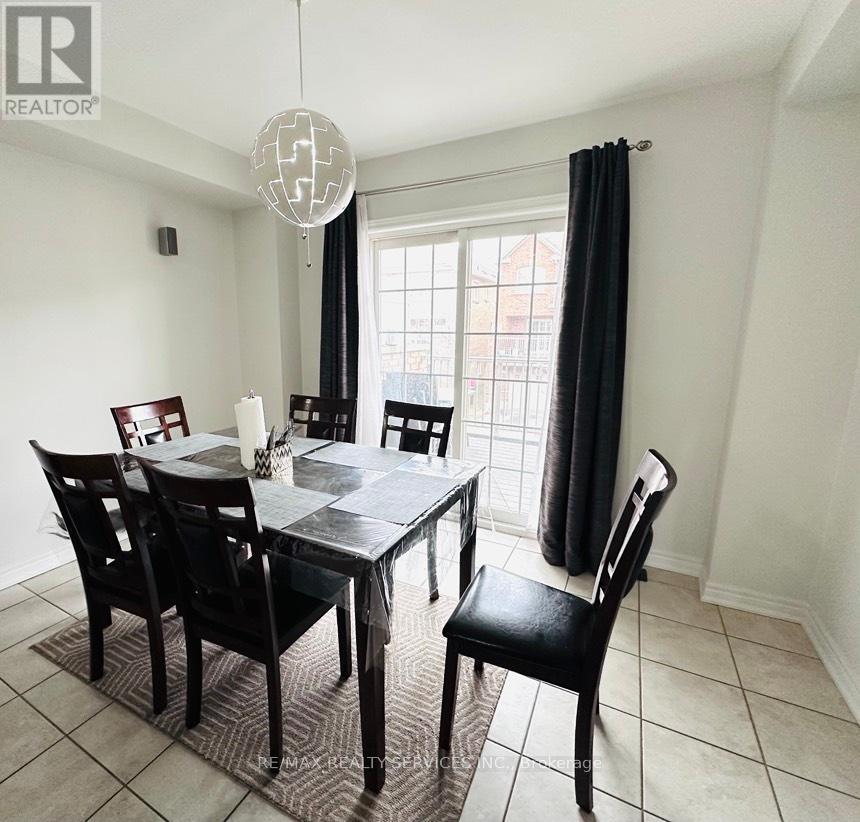 A dining room with a table and chairs.
