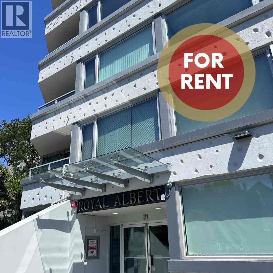 A multi-story building with a "FOR RENT" sign in front.
