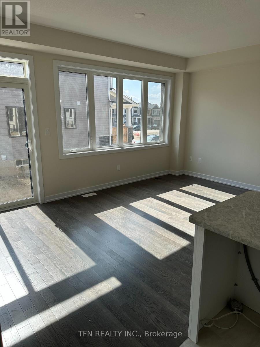 A room with a large window and sliding glass doors.