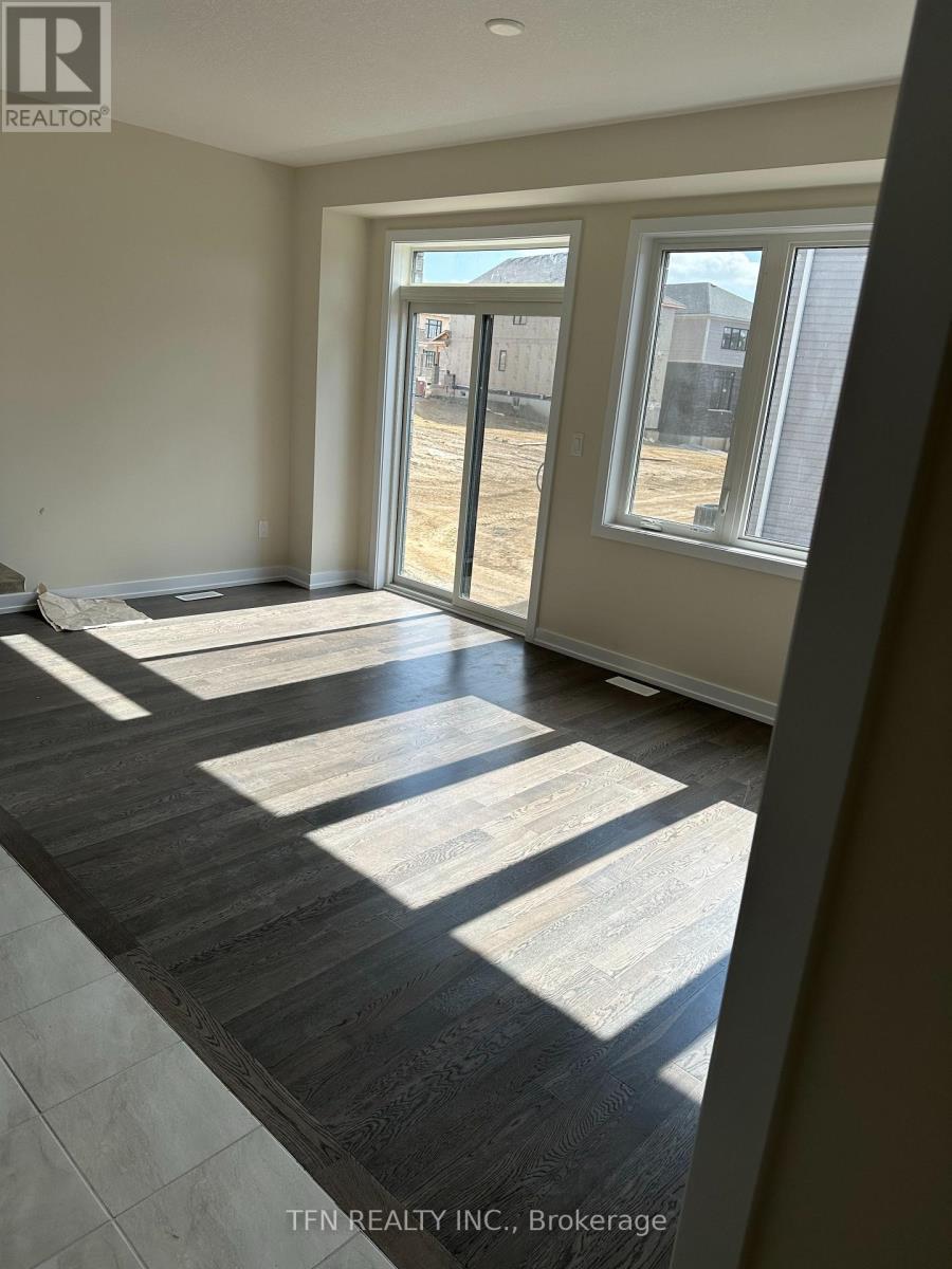 A room with a large window and a sliding glass door.