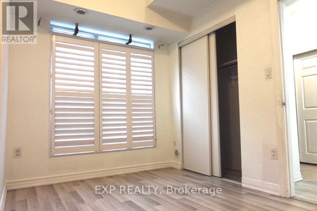 A room with white shutters and a door.
