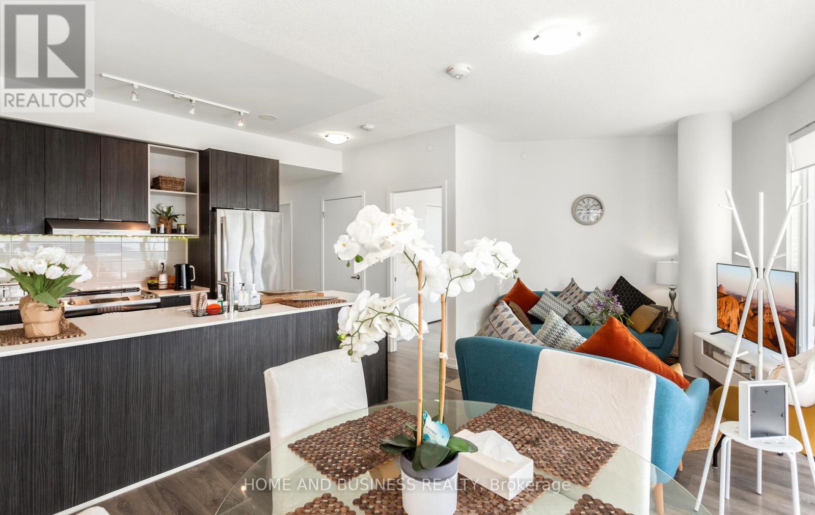 A modern kitchen with a dining table set for two.
