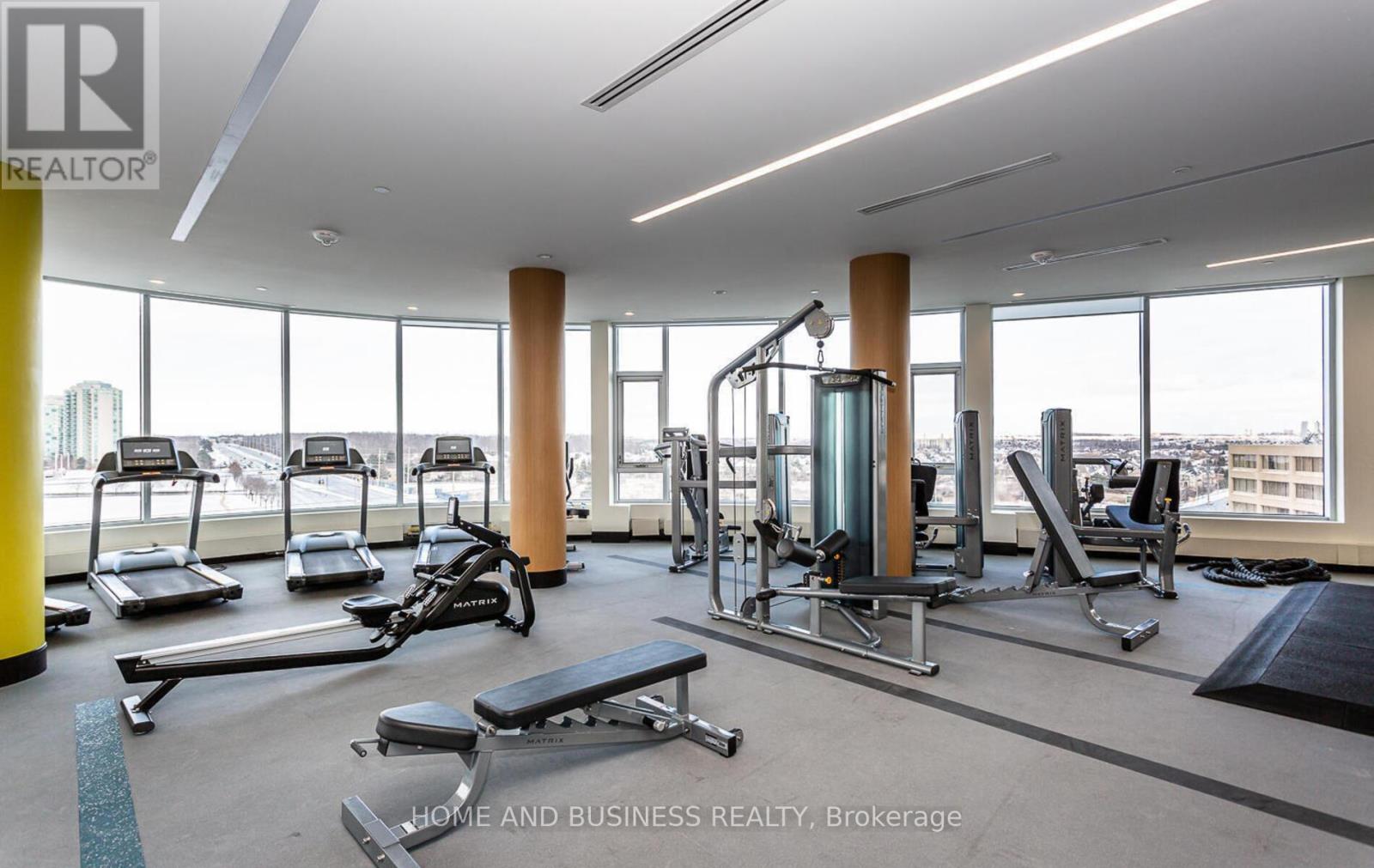 A gym with treadmills, weights, and exercise equipment.