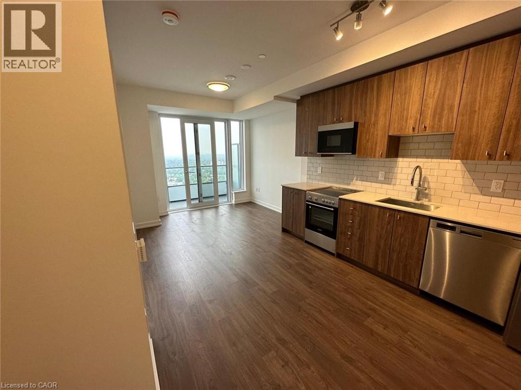 A kitchen with wooden cabinets and stainless steel appliances.