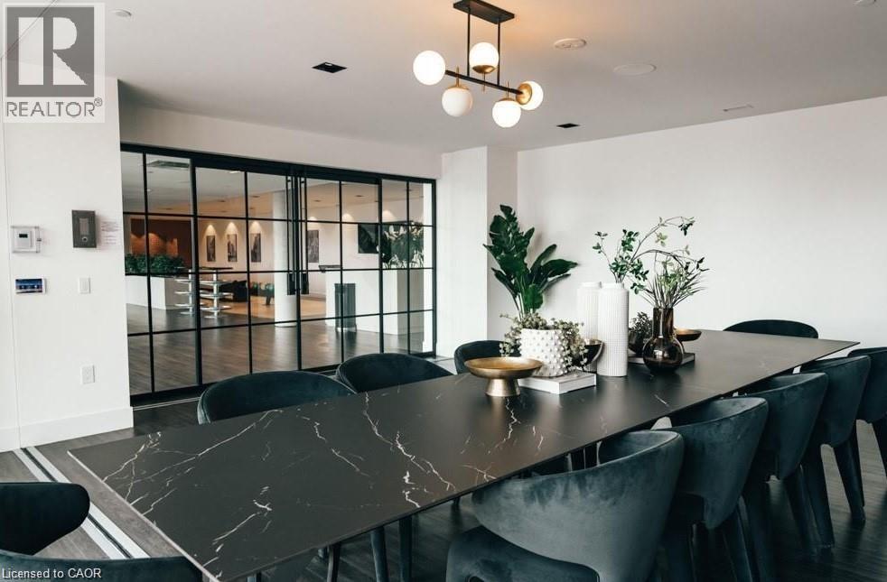A modern dining room with a long table and chairs.