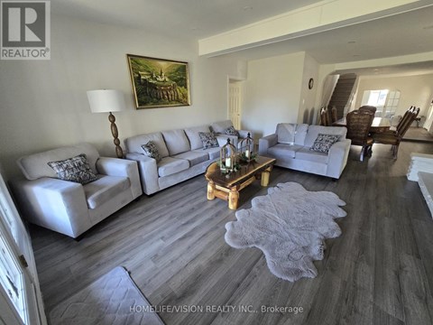 A living room with a grey couch and a wooden coffee table.