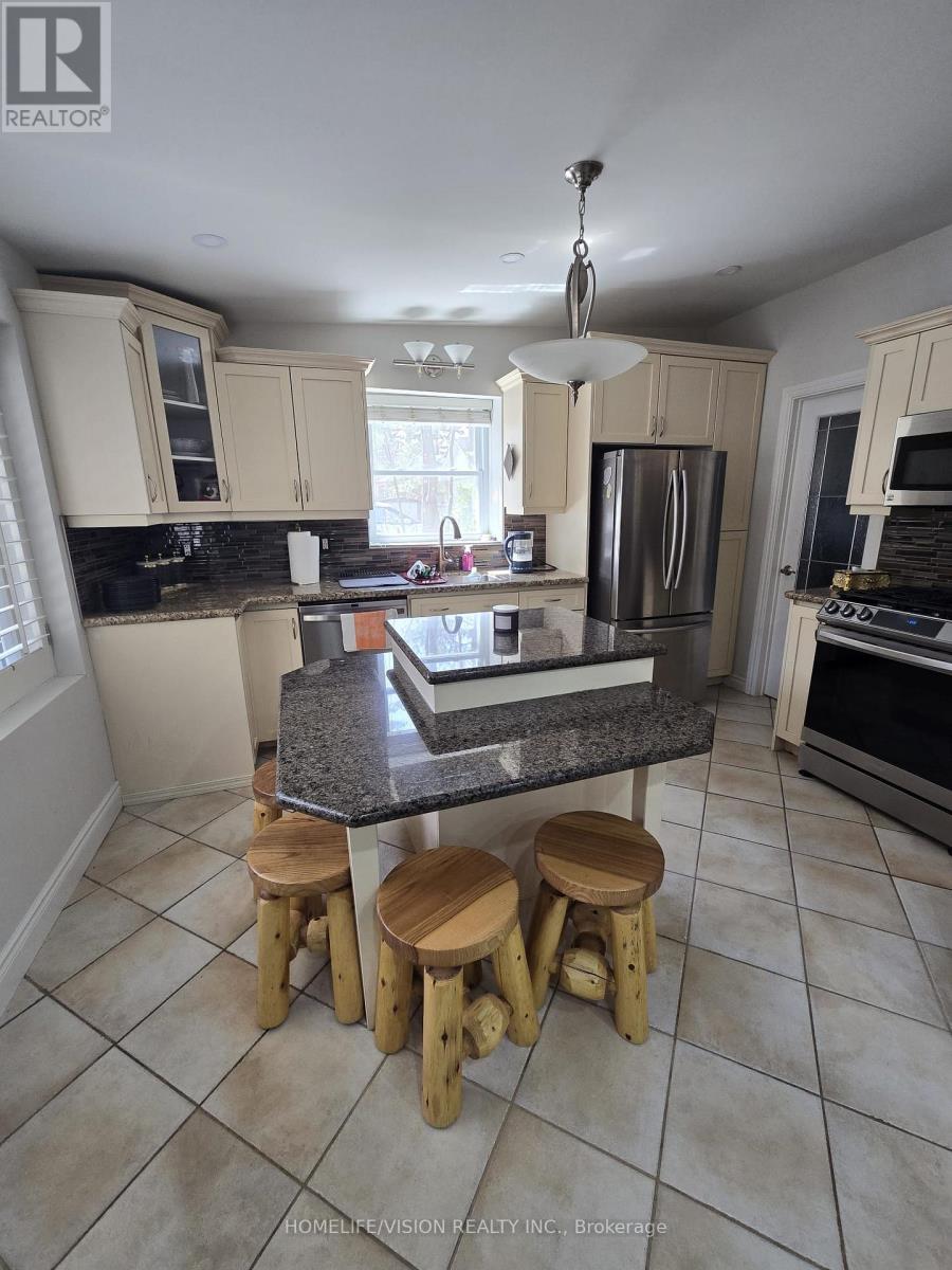 A kitchen with a granite countertop and wooden stools.