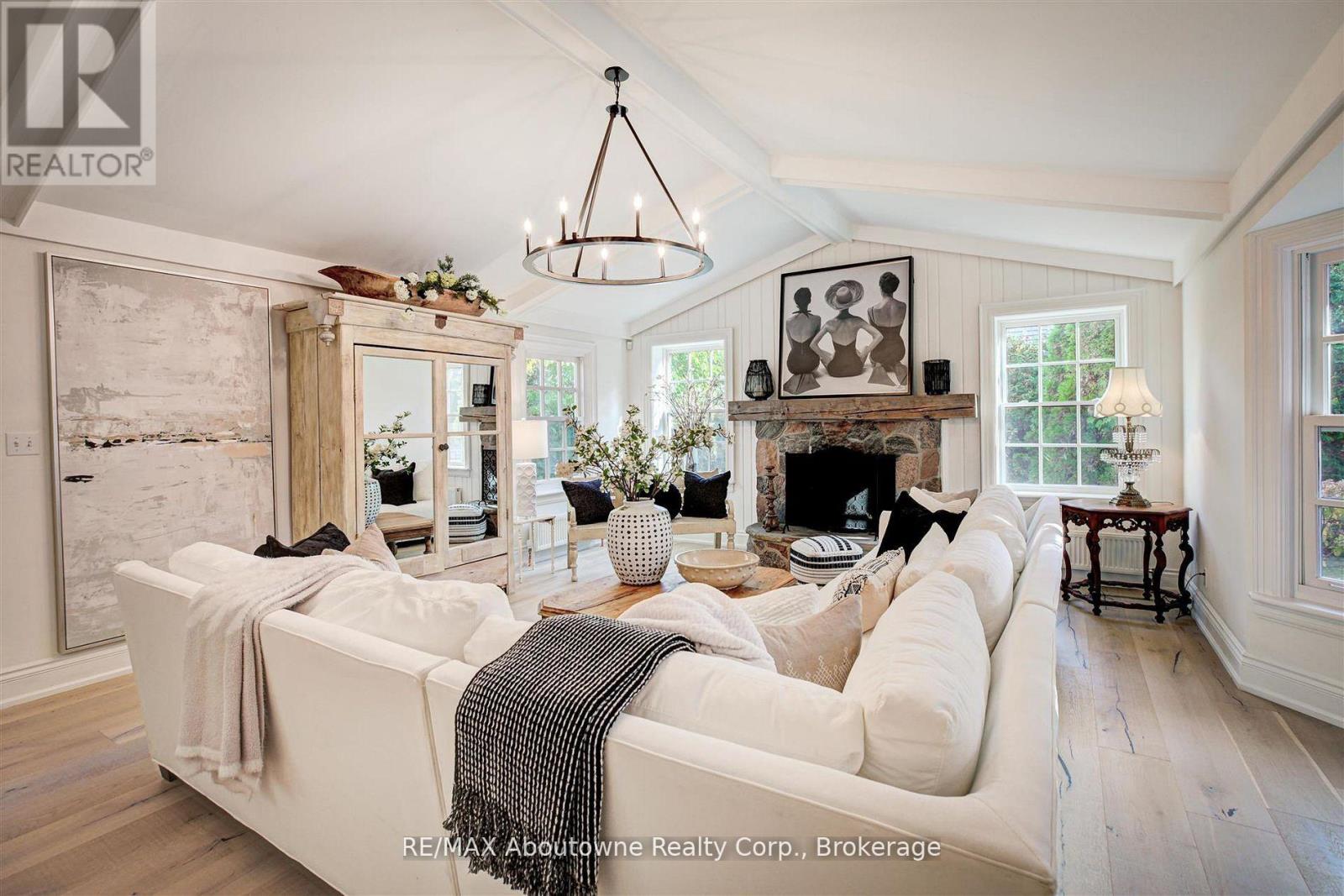 A living room with a white couch and a fireplace.