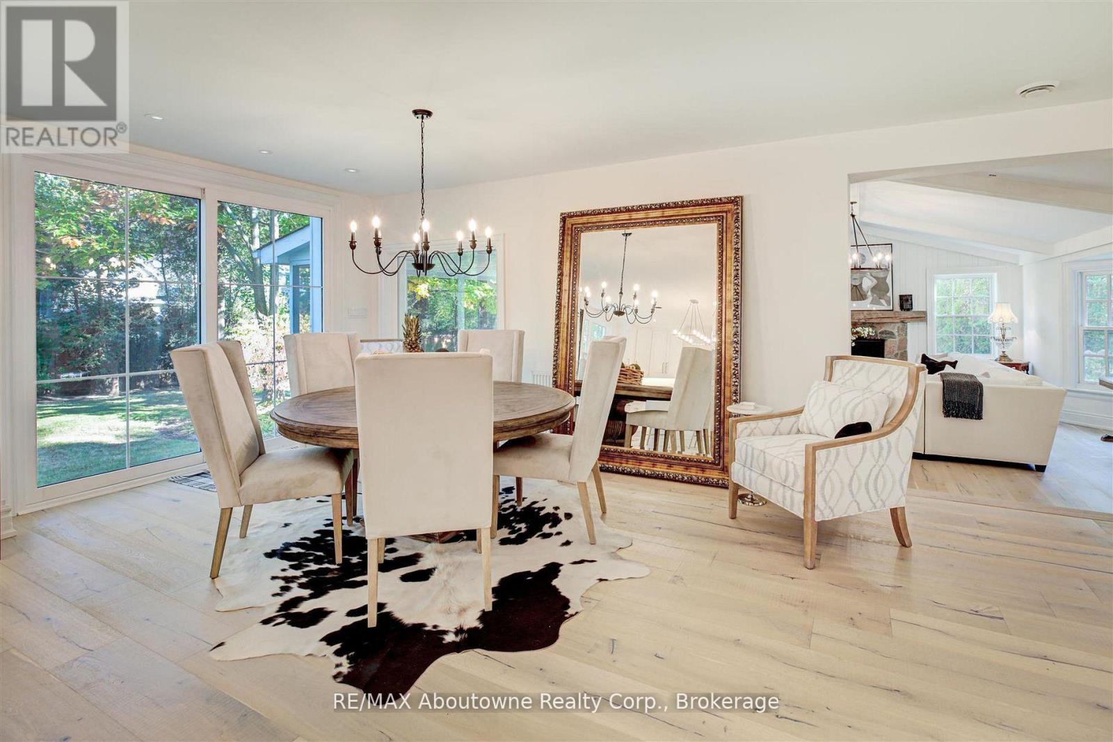 A dining room with a wooden table and chairs.