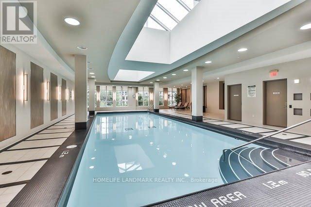 A swimming pool in a large indoor space with the words "HOMELIFE LANDMARK REALTY INC. Brokerage" on the side.