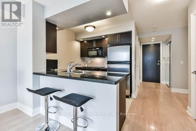 A modern kitchen with a bar stool.