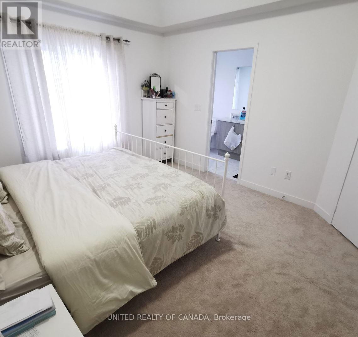 A bedroom with a large bed and a dresser with a mirror.