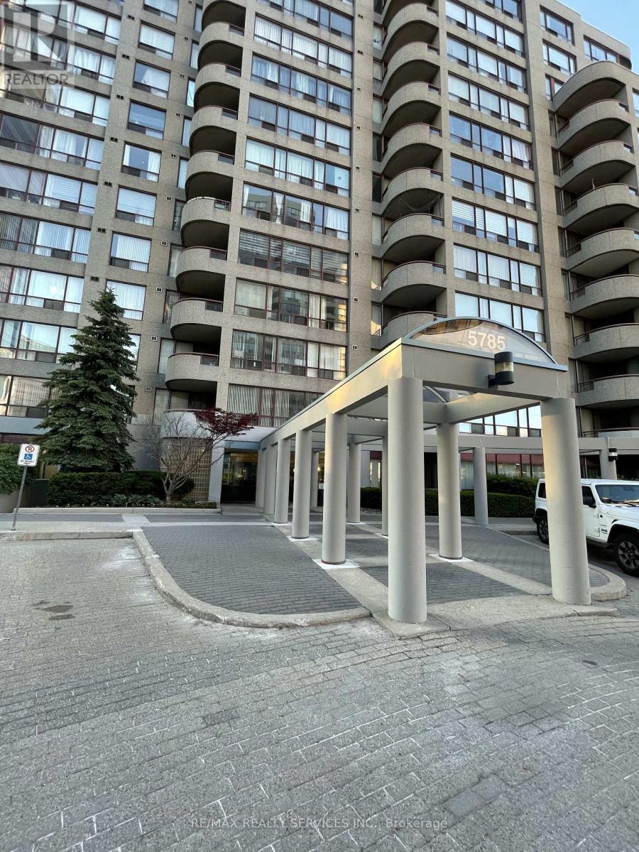 A tall building with a tree in front of it.