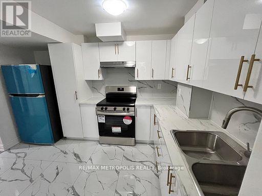 A kitchen with white cabinets and a marble countertop.