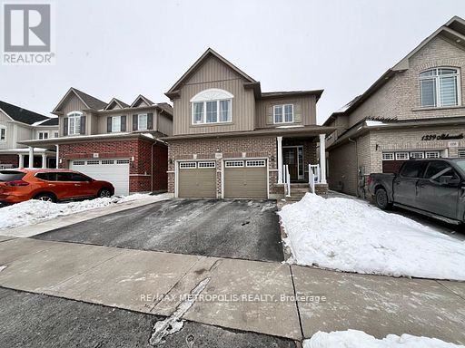 A real estate photo shows a house with a driveway and garage.