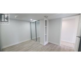 A white room with a sliding door and a wooden floor.