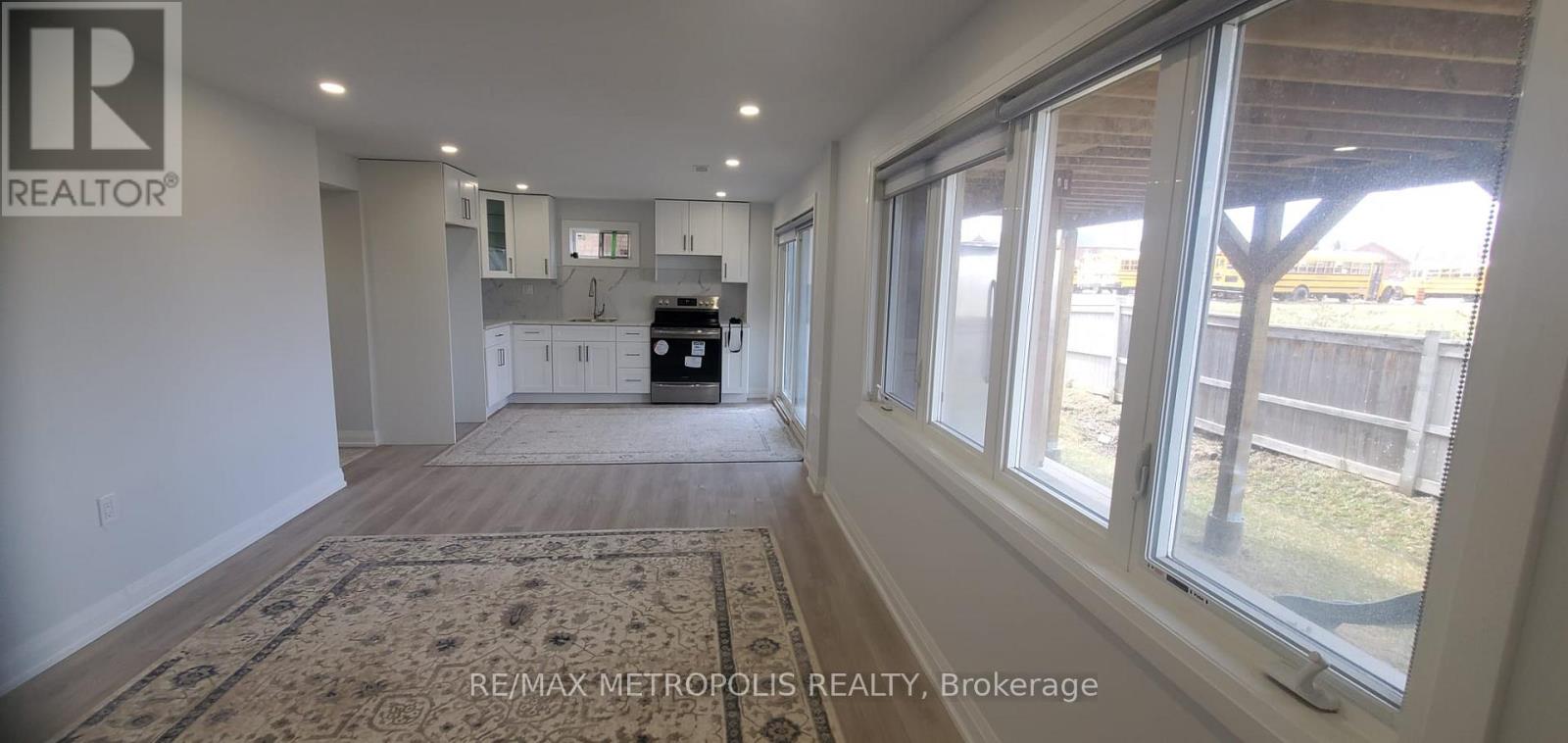 A realtor's office with a large window overlooking a backyard.