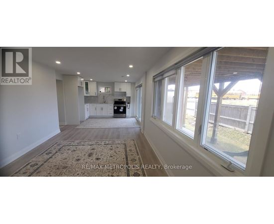 A realtor's office with a large window overlooking a backyard.