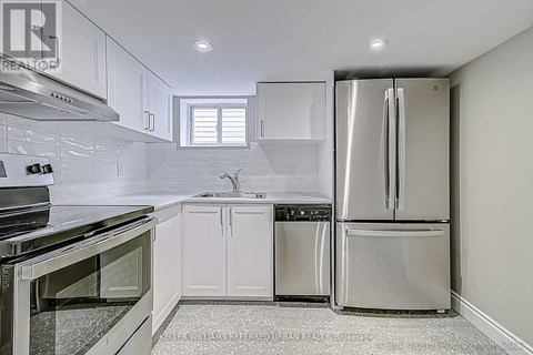 A kitchen with white cabinets and stainless steel appliances.