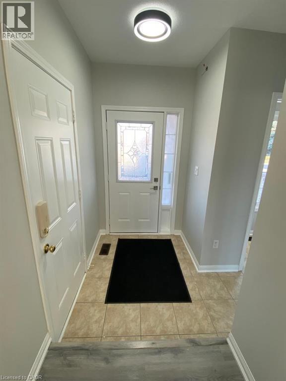 A hallway with a black mat on the floor.