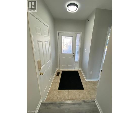 A hallway with a black mat on the floor.