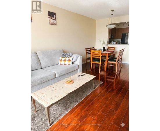 A living room with a grey couch and a coffee table.
