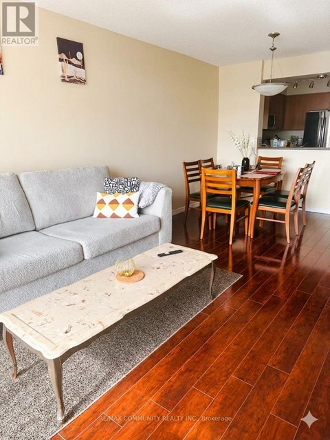 A living room with a grey couch and a coffee table.