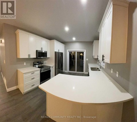 A kitchen with white cabinets and a large island.