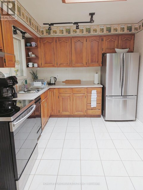 A kitchen with wooden cabinets and a black stove top oven.