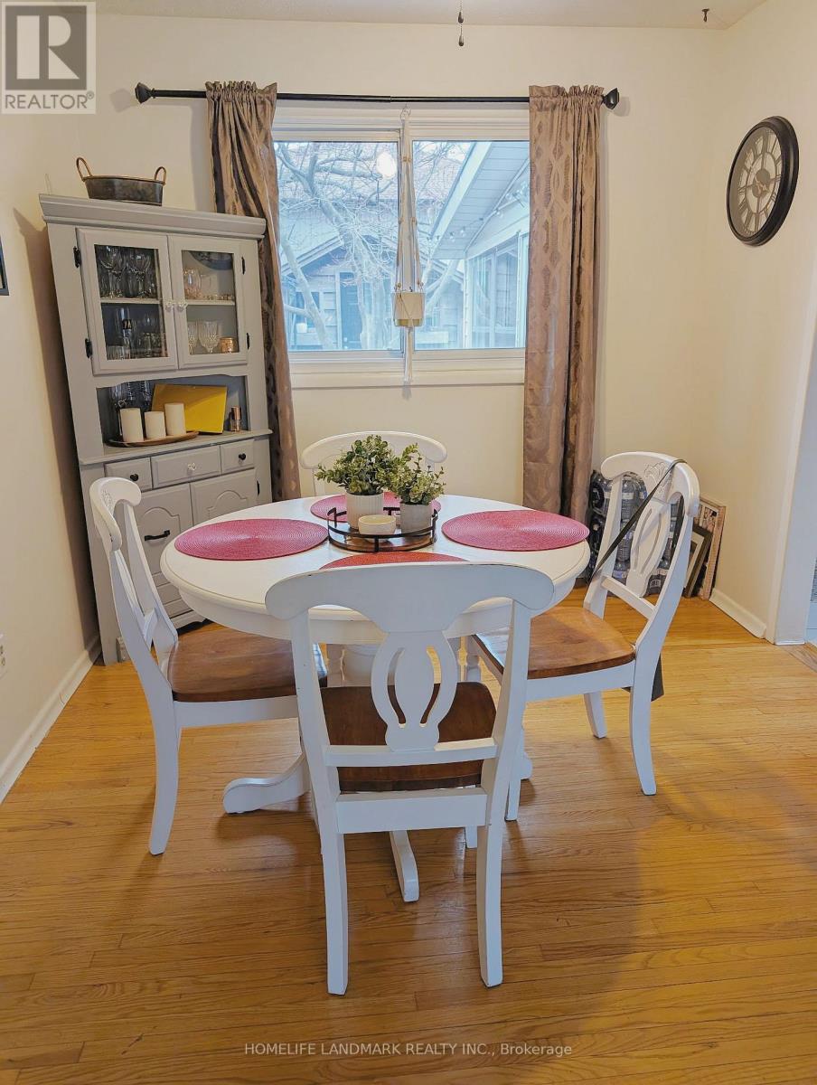 A dining room with a white table and chairs.