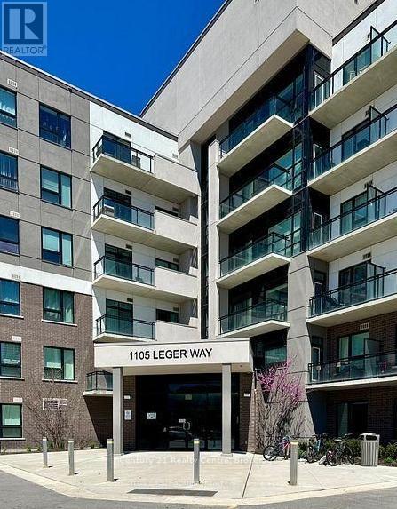 The image shows a modern building with the sign "1105 LEGER WAY" in front of it.