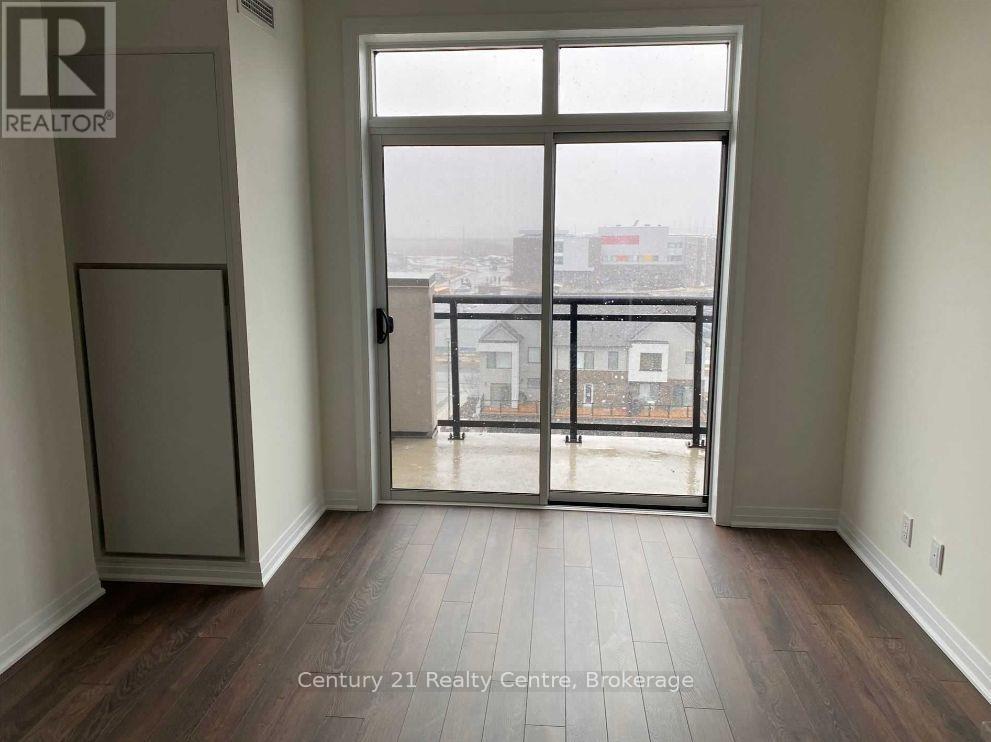A room with a view of the city through a large window.