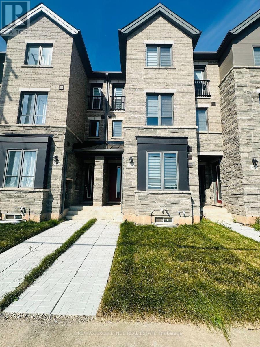 A modern stone building with a clear blue sky in the background.