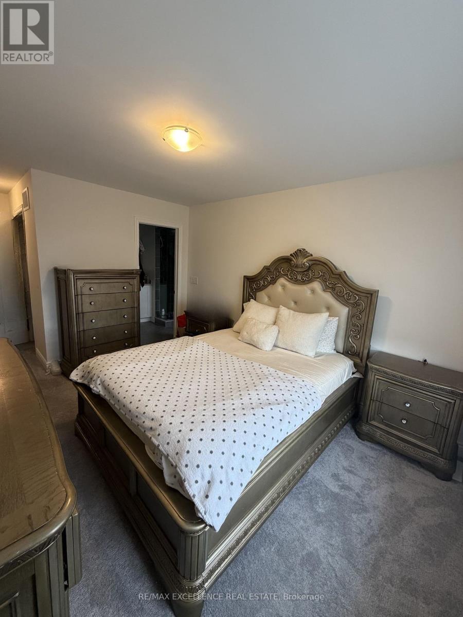 A bedroom with a large bed and a dresser.