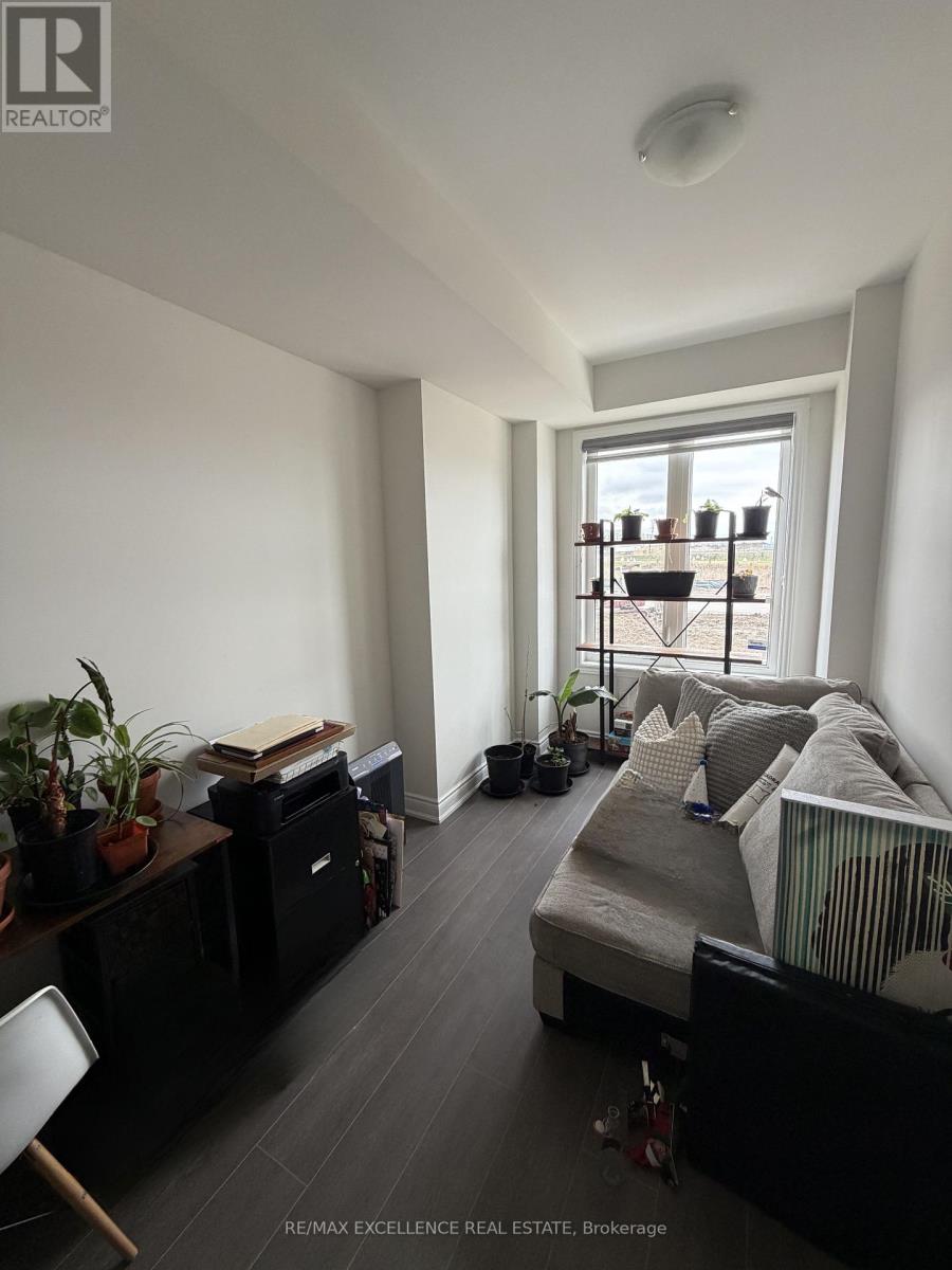 A bedroom with a bed, desk, and chair.